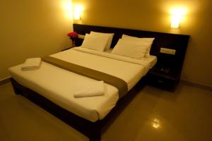 Voodi või voodid majutusasutuse Hotel Sunshine toas