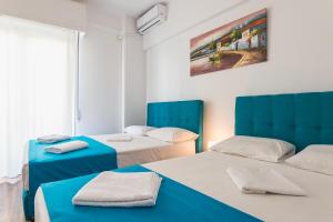 Postel nebo postele na pokoji v ubytování Super Paradise Apartments
