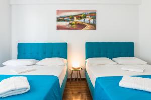 Postel nebo postele na pokoji v ubytování Super Paradise Apartments