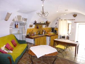 a living room with a couch and a kitchen at Chambre d'hôtes La Romarine in Barnave +96 photos