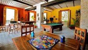 a living room with a pool table and a table at Hacienda San Francisco Tzacalha in Dzidzantún