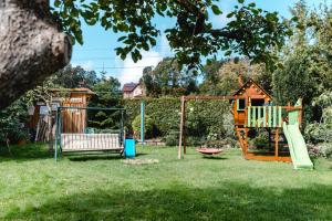 a playground in a yard with a tree at Ferienwohnung Franke in Heilbad Heiligenstadt