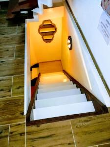 a set of stairs with yellow walls and wooden floors at WOHLFÜHLOASE - Zimmer, Appartment - im Herzen STARNBERGS in Starnberg
