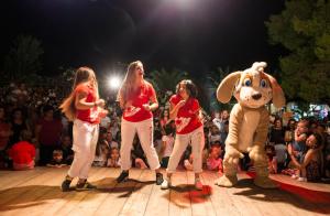 a group of girls walking on a stage in front of a crowd at Vascellero Club Resort in Cariati +89 photos