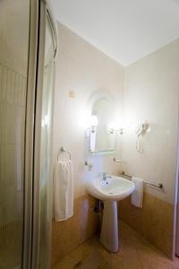 a bathroom with a sink and a shower at Hotel Class in Constanţa