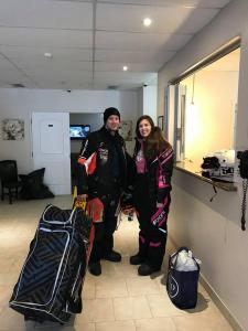 a man and woman standing in a room with their luggage at Auberge MacDonald Guest Inn in Iroquois Falls