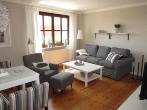 a living room with a couch and a table at Ferienhaus Elbblick in Tangermünde