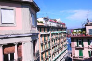 a group of buildings in a city with a river at Megaride Santa Lucia in Naples
