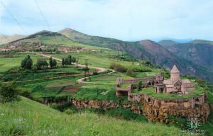 an old building on a hill in a field at Saro B&B and Safari Tours in Tatʼev