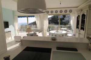a kitchen and living room with a view of the ocean at La Reale in Villefranche-sur-Mer