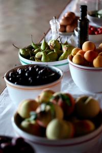 a table topped with bowls of apples and other foods at La Foresteria Planeta Wine Resort & Beach Club in Menfi