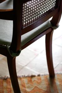 a wooden chair sitting on top of a rug at La Foresteria Planeta Wine Resort & Beach Club in Menfi