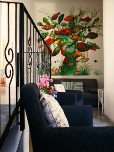 a living room with a couch and stairs with a painting at Apartments-Estate under the Paintbrush in Vis