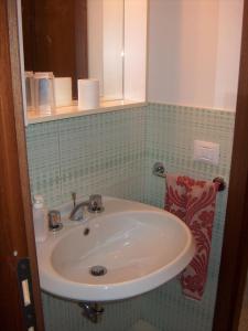 a bathroom with a sink and a mirror at RESIDENZA LEON D'ORO in Cesena