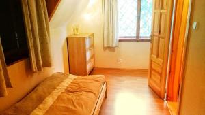a small bedroom with a bed and a window at Chata Tatry in Tatranska Strba