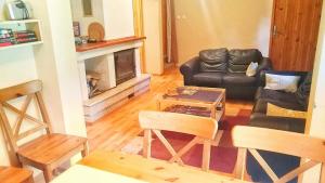 a living room with a couch and a fireplace at Chata Tatry in Tatranska Strba