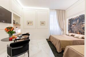A bed or beds in a room at Cavour Suites Guest House