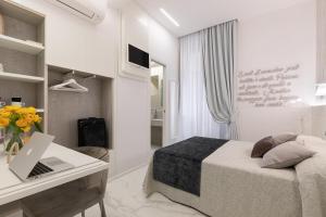 A bed or beds in a room at Cavour Suites Guest House