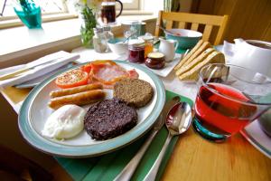 a plate of breakfast food on a table at Heatherlea in Kirkwall