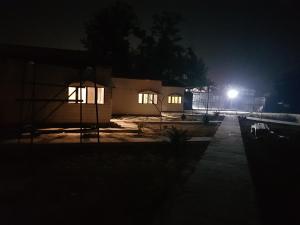 a house lit up at night with a street light at Living Green Farms in Allahābād