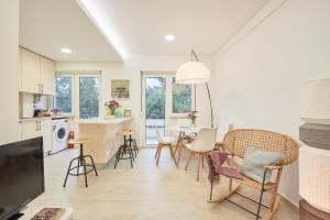 a kitchen and dining room with a table and chairs at Light Apartment With Amazing Balcony, by TimeCooler in Lisbon