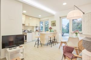 a kitchen and living room with a table and chairs at Light Apartment With Amazing Balcony, by TimeCooler in Lisbon