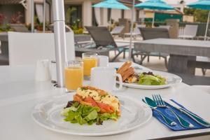 a table with two plates of food and drinks at Beach View Hotel in Saint James