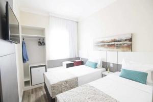 Postel nebo postele na pokoji v ubytování Hotel H2 Congonhas