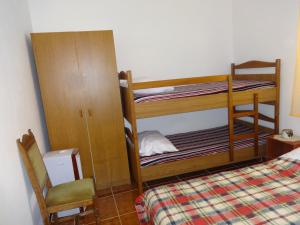 a bedroom with two bunk beds and a chair at Apartments Palma in Vir