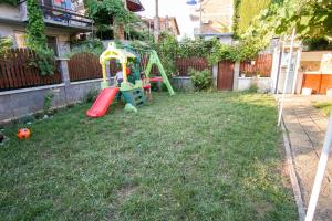a small yard with a playground in a backyard at Guest House Gardeli in Tsarevo