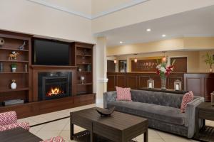 a living room with a couch and a fireplace at Ramada by Wyndham Elizabethtown in Elizabethtown