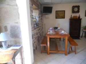 a dining room with a table with food on it at Annie jouve chambres d'hôtes champassis in Vebret