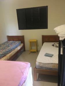 a room with two beds and a tv on the wall at Espaço Smidt in Santa Branca +16 photos