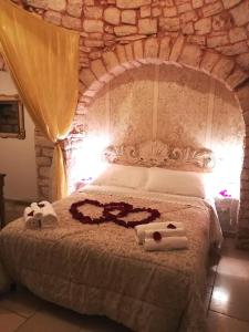 Postel nebo postele na pokoji v ubytování Trulli Resort Dimore Storiche
