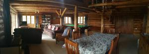 a living room with a table in a log cabin at Ruapehu Log Lodge in Raetihi