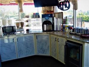 a kitchen with a counter top with a microwave at Budget Inn Conway in Conway