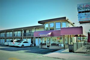 a building with cars parked in a parking lot at Budget Inn Conway in Conway