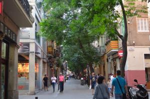 a group of people walking down a city street at Bed&BCN Gracia II in Barcelona