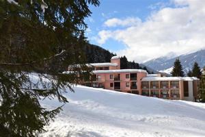 a building on top of a snow covered mountain at Ski-Garden in Mezzana