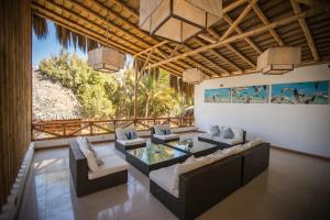 a living room with couches and a glass table at Aranwa Vichayito Beach Resort in Vichayito +50 photos