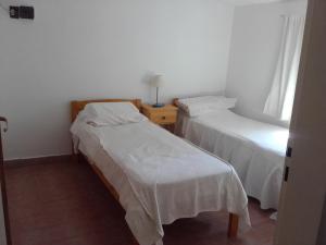 En eller flere senge i et værelse på Casa soñada con vista a la Sierra de los Comechingones