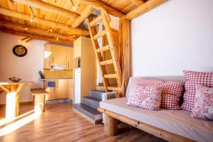 a living room with a couch and a staircase at Nieve in Sierra Nevada