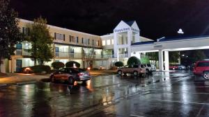 a parking lot in front of a hotel at night at Days Inn by Wyndham Chattanooga/Hamilton Place in Chattanooga