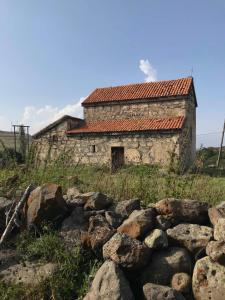 an old stone building in a field with rocks at Oasis in Aspindza