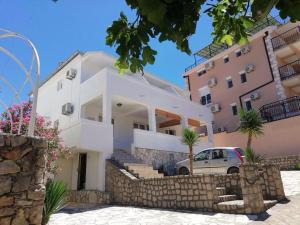 a house with a car parked in front of it at Villa Nautica in Luštica