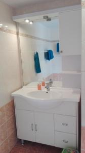 a bathroom with a white sink and a mirror at Apartmány Mamut Harrachov in Harrachov +41 photos