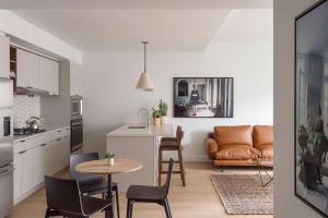 a kitchen and living room with a table and chairs at ROOST East Market in Philadelphia