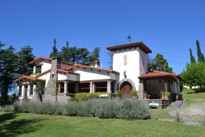 a large white building with a tower at Ca´Montana Hostal Boutique in La Falda