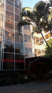 a reflection of a building with a palm tree in front of it at Hotel del Sur in San Lorenzo