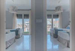 A bed or beds in a room at BeHouse Avenida
